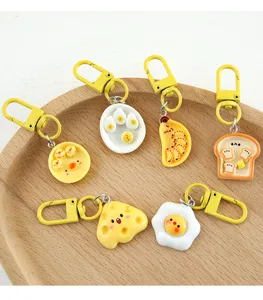 Set of six creative simulation food resin keychains displayed on a wooden plate