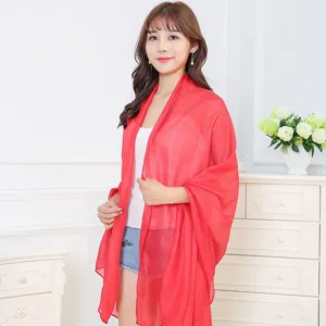 Elegant vibrant red lightweight cotton-linen shawl draped gracefully over model shoulders