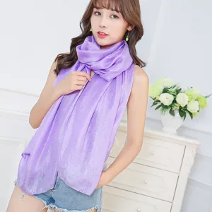 Close-up of a light purple linen pashmina scarf with pearl luster finish worn by a model.