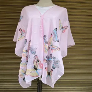 Detail view of pink chiffon sun protection shawl with vibrant butterfly print on mannequin