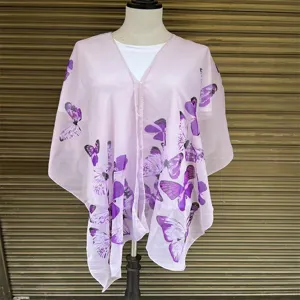 Detailed view of the sheer light pink shawl featuring vibrant purple butterfly prints