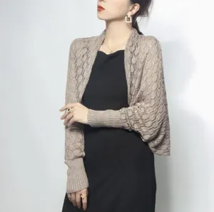 Detail view of a stylish brown honeycomb crochet bolero shrug shawl on a model.