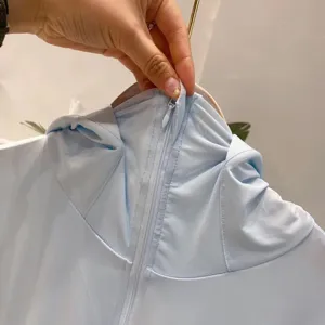 Close-up of the zipper and breathable mesh on a light blue hooded sun protection jacket
