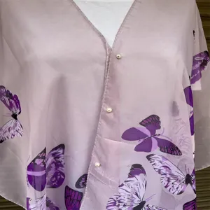 Detailed macro view of sheer lavender shawl featuring vibrant purple butterfly prints and pearl buttons