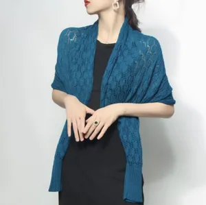 Detailed view of women's blue knit shawl with elegant honeycomb pattern texture