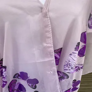 Close-up detail of lightweight purple butterfly print faux silk sun protection shawl wrap