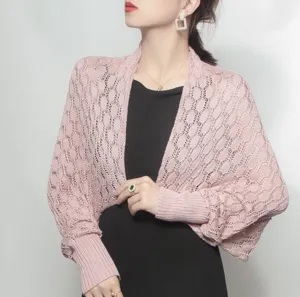 Close-up of a pink honeycomb knit shawl shrug showing the detailed texture and sleeve