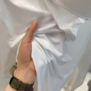 Close-up of lightweight breathable white UV protection fabric for summer outdoor jacket