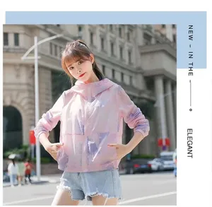 Detailed view of women's pink printed breathable sun protection jacket outdoors