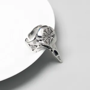 Detail of Viking raven skull ring with engraved Norse Vegvisir and Valknut runes.