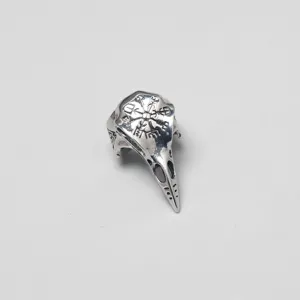 Detailed view of a vintage silver Viking raven skull ring with Nordic rune engravings