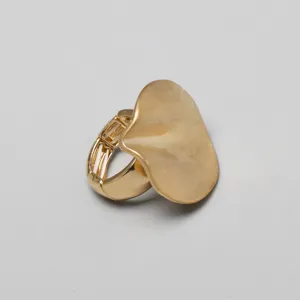 Primer plano de un anillo elástico dorado con un disco ondulado irregular moderno