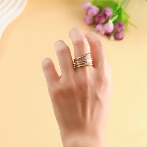 Close-up of high quality three-layer stackable minimalist stainless steel rings on a finger