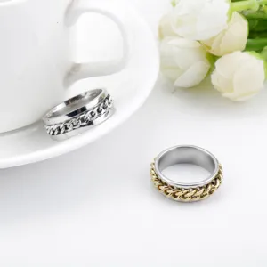 Detail shot of stainless steel spinning chain rings in silver and gold-tone finishes