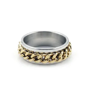 Detail view of rotating stainless steel spinner ring featuring golden chain link inlay