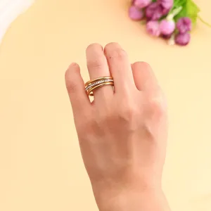 Macro view of a gold-plated triple stacked titanium steel ring with micro-zirconia inlay