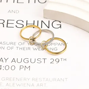 Close-up detail of three-layer stacked titanium steel rings with elegant crystal accents
