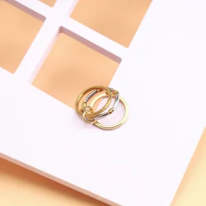 Detailed view of three-layer stackable titanium steel rings with mixed metal finishes