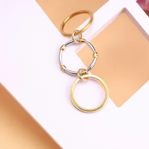Detail shot of three-layer stacked titanium steel rings in gold and silver finish