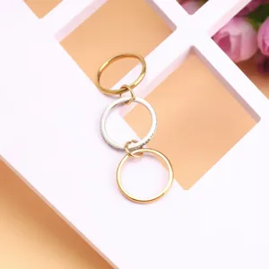 Close-up of triple-layer stacked titanium steel rings in gold and silver finish