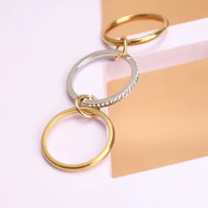 Macro detail of triple-layer stacked interlocking rings featuring sparkling crystal pave accents
