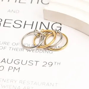 Close-up of interlocking stackable stainless steel rings in gold and silver finish
