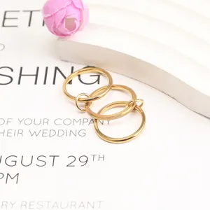 Detailed macro view of triple-layered gold titanium steel rings with textured finish.
