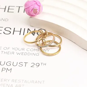 Detailed macro view of gold-plated stackable stainless steel rings with shimmering crystals