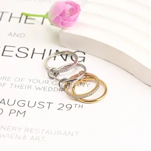 Close-up of interlocking gold and silver titanium steel rings on elegant card background