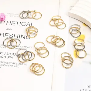 Close-up of minimalist titanium steel three-layer stacked rings on white background