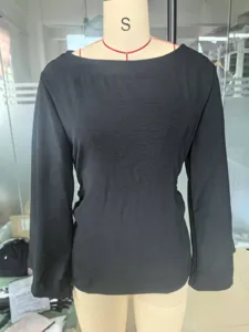 Elegant solid black boat neck long sleeve top with flared bell sleeves on a mannequin