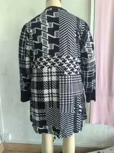 Back view of a women's black and white geometric patchwork cardigan on mannequin
