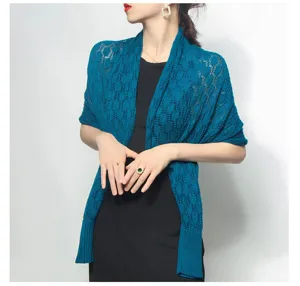 Detailed view of a teal honeycomb hollow knitted shawl scarf worn by an elegant model