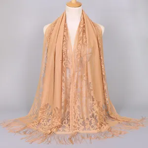 Detail view of breathable nylon lace shawl with hollow-out pattern and tassels.