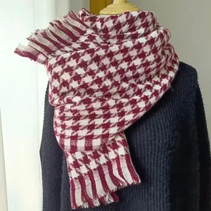 Close-up of maroon and white houndstooth scarf with elegant tassel details for winter