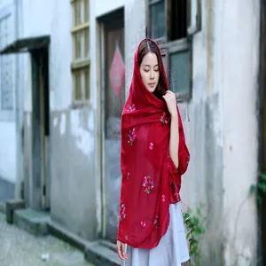 Red cotton-linen scarf with delicate plum blossom embroidery on an Asian model