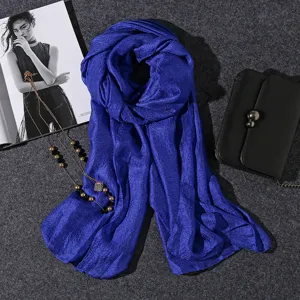 Close-up of royal blue pearl sheen scarf with linen-cotton texture for beach travel.