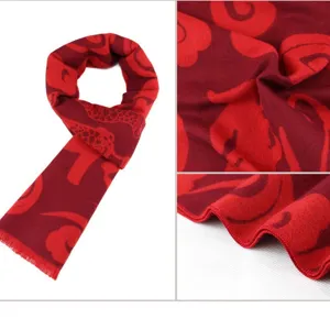 Detailed macro view of red cashmere scarf with traditional Chinese cloud patterns