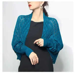 Detailed view of peacock blue honeycomb knitted shrug with breathable openwork design