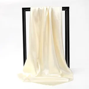 Detailed view of champagne satin square scarf showing elegant drape and silk-like luster