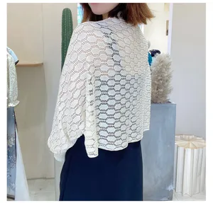 Detailed view of white honeycomb knit hollow-out breathable shawl for sun protection