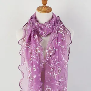Close-up of purple gauze scarf featuring floral prints and delicate lettuce edge details.