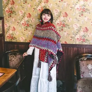 Bohemian ethnic style knit shawl poncho with colorful patterns and tassel details
