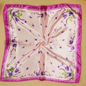 Close-up of pink silk square scarf with purple thistle floral pattern for business uniform