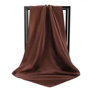Macro view of chocolate brown silky square scarf with elegant draping and smooth texture