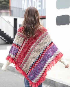 Back view of ethnic style knitted autumn winter poncho with colorful patterns and tassels