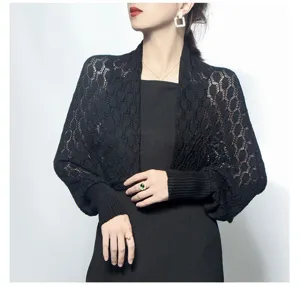 Detailed view of black knitted honeycomb hollow shawl with ribbed cuffs on model