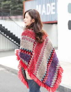 Detailed back view of a bohemian knit poncho with colorful zigzag patterns and fringes.