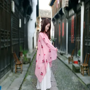 Elegant pink embroidered cotton linen shawl with ethnic floral patterns in scenic street