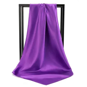 Purple satin square scarf draped over a black frame, showcasing its smooth silk texture.